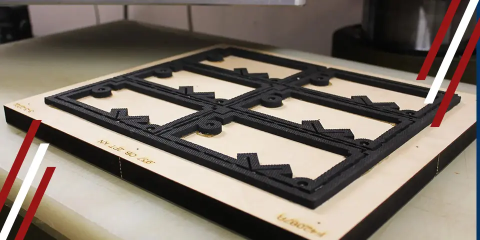 A die-cutting plate with six rectangular cutouts rests on a surface. The cutouts contain smaller, intricate designs. "MY 157 BO 266" is visible on the plate.